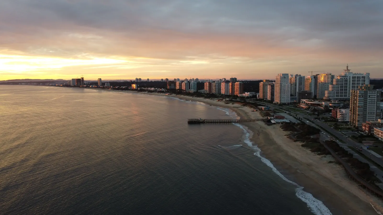 Playa Mansa and the Punta del Este promenade at dusk, seen from the air